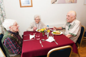 Residents having dinner in the communal area