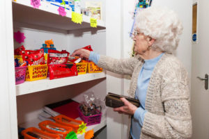 Old lady picking products from the shop