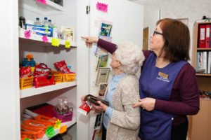 Claire helping resident to pick shop items