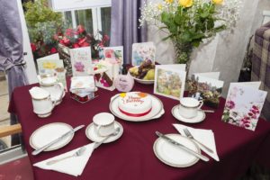 Cards, presents and cake on table for residents birthday