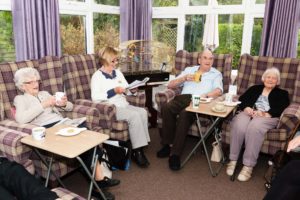 The residents having tea in the living room